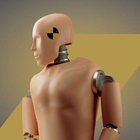 Un mannequin de crash test avec un symbole de cible jaune et noir sur la tête est placé sur un fond gris-jaune flou.