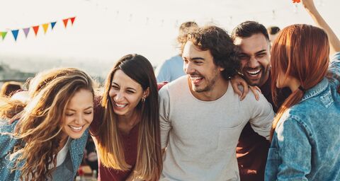 A group of young people celebrates a feast and everyone is happy.