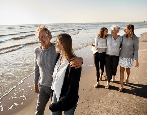 Eine Familie macht gemeinsam einen Spaziergang am Strand.