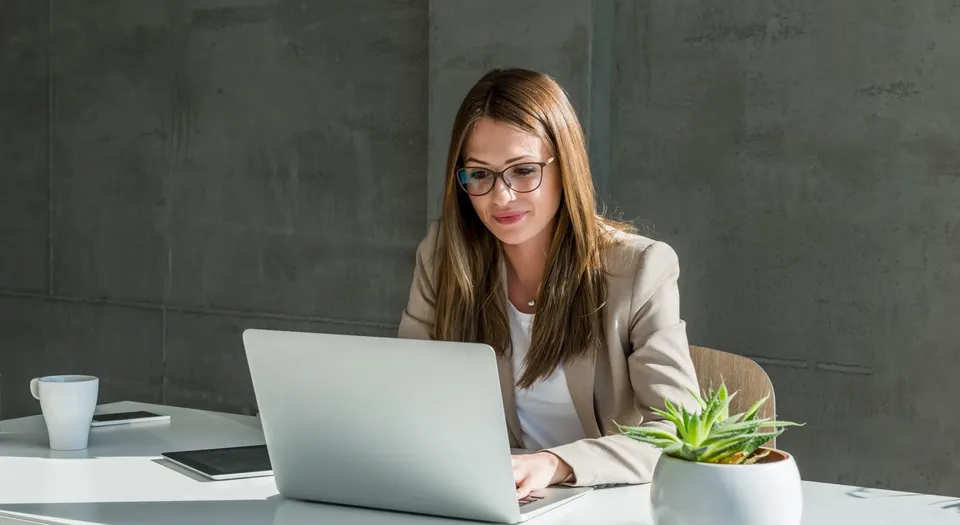 Businesswoman working at a laptop in a modern office