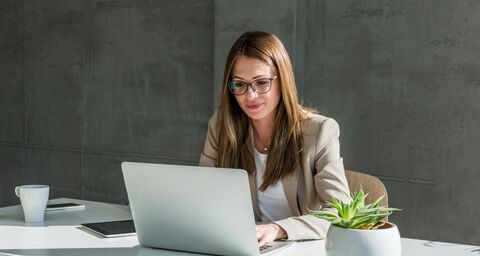 Businesswoman working at a laptop in a modern office