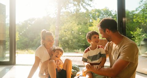 A family is sitting laughing in the lounge.